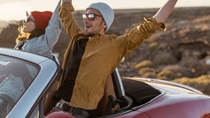 People cheering in a cabriolet People cheering in a cabriolet