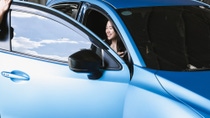 woman sitting in blue car