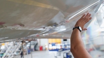 Separate patches of the functional NovaFlex SharkSkin film are manually applied to the surface of the aircraft.