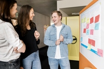 Three young DIU employees talking and laughing