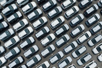 Aerial view of new cars stock at factory parking lot. Above view cars parked in a row. Automotive industry. Logistics business. Import or export new cars at warehouse. Big parking lot at port terminal; Shutterstock ID 2294782551; purchase_order: -; job: -; client: -; other: -