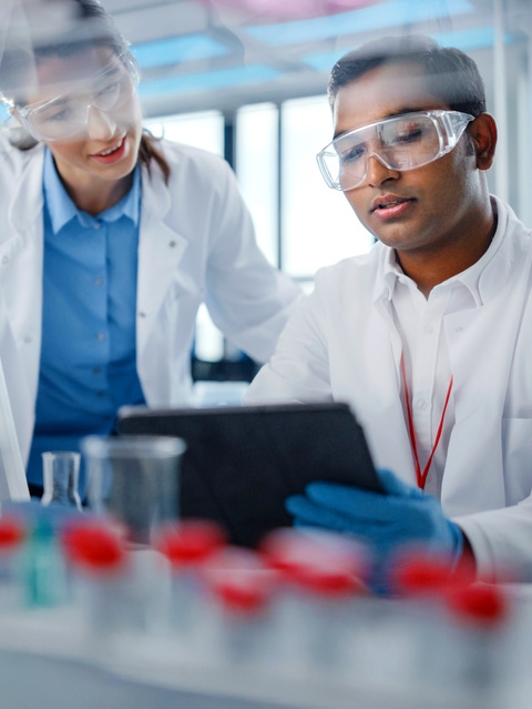 People in a lab with a tablet in their hands