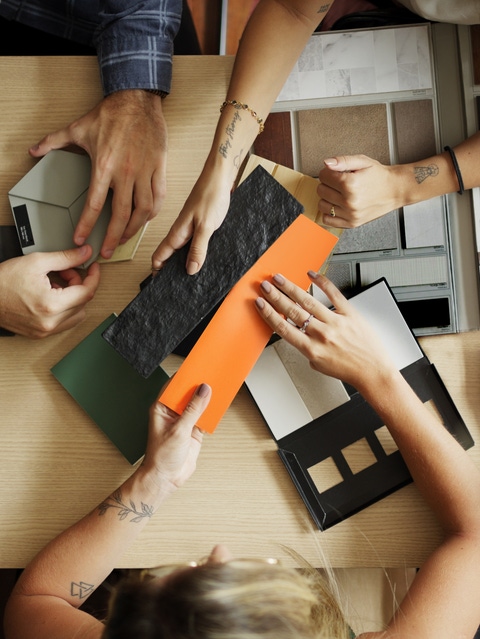 People at a table looking at different colours