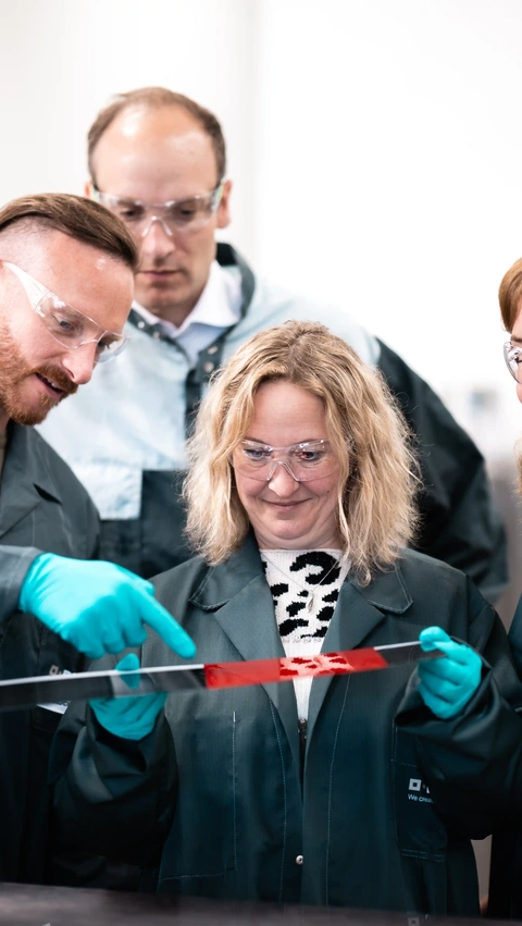 Group of scientists looking at color panel.