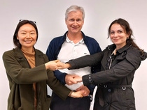 Three employees from the network CultiConnect holding hands Three employees from the network CultiConnect holding hands